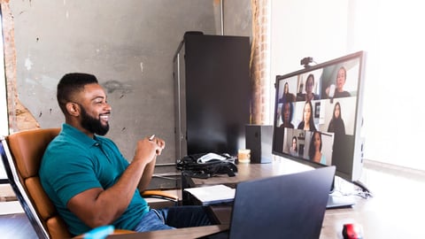 Professional on a video call, representing the enhanced collaboration solutions from Yorktel and Kinly